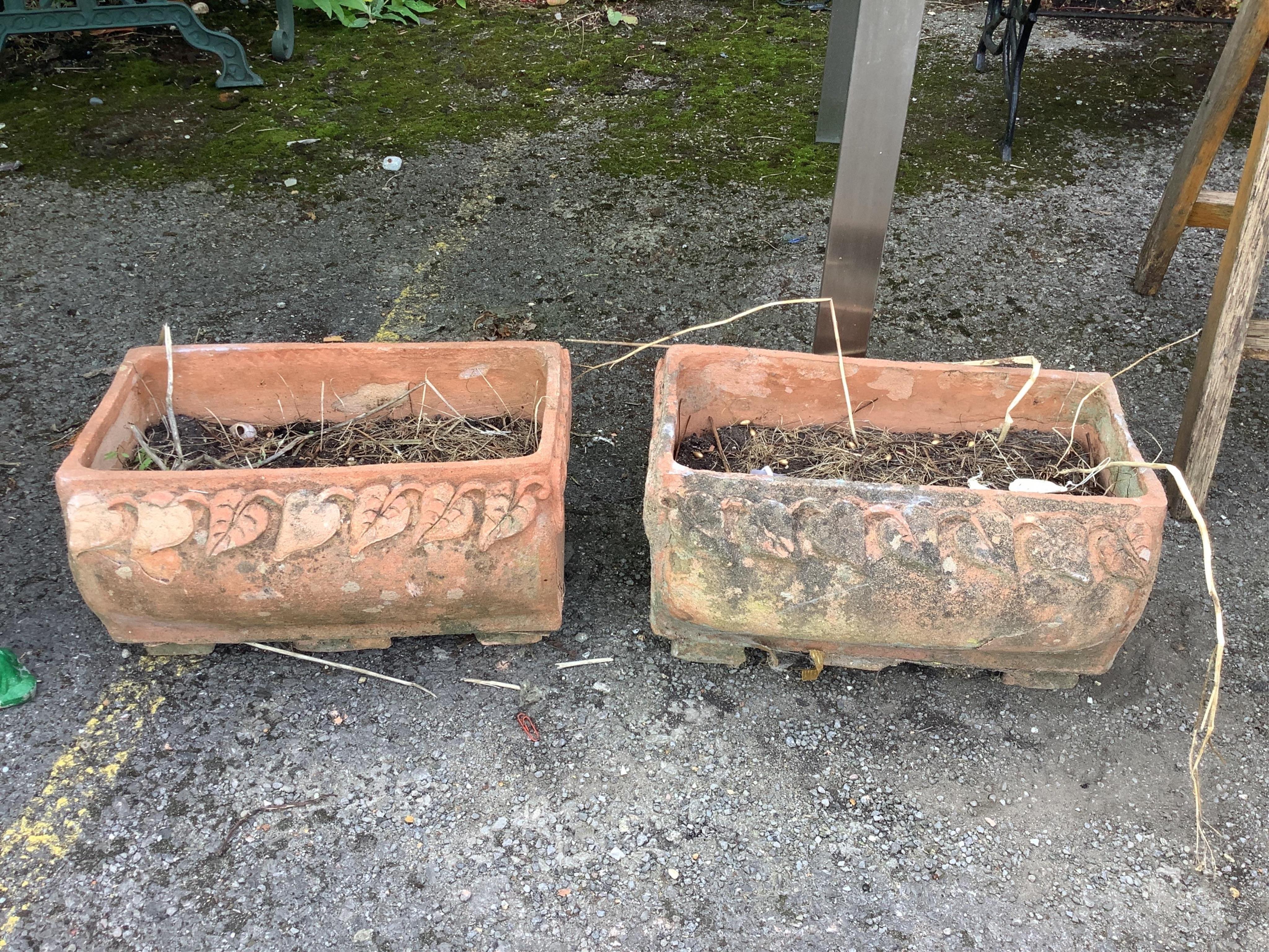 A pair of rectangular terracotta garden planters, width 40cm, depth 22cm, height 22cm. Condition - fair